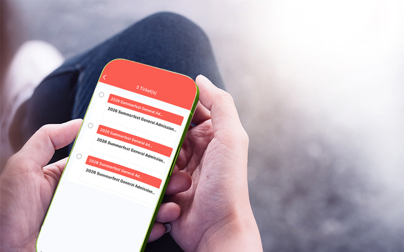Image of someone holding a phone with the Summerfest App launched
