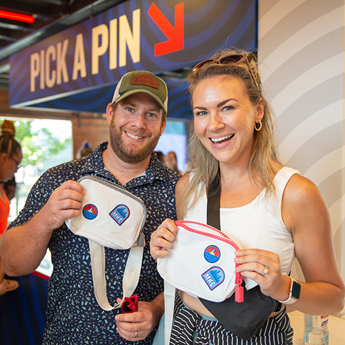 Couple holding bum sacks that they decorated at Summerfest